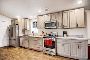 Grand Canyon train house fully stocked kitchen with brand new appliances and white, industrial looking cabinetry