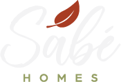 Sabé homes logo white with rusty red leaf and green accent